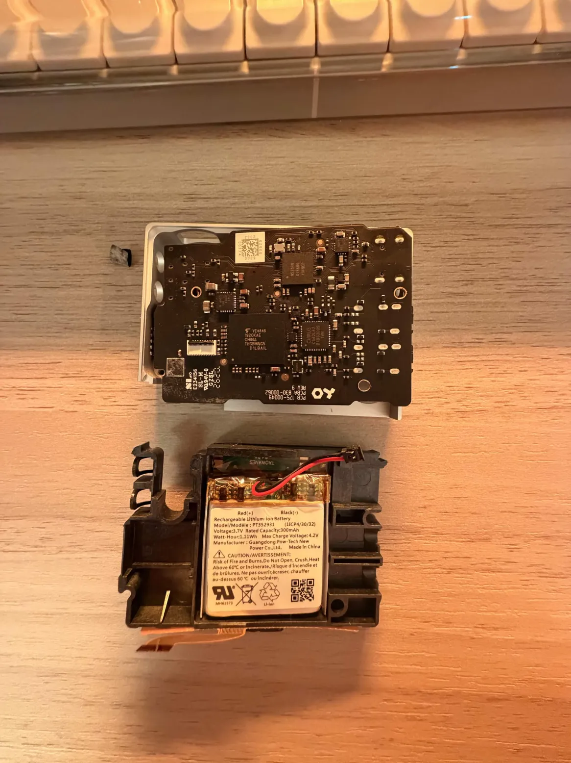 The SP-1 fully separated: the main board above, the LiPo battery seated in the lower case half below
