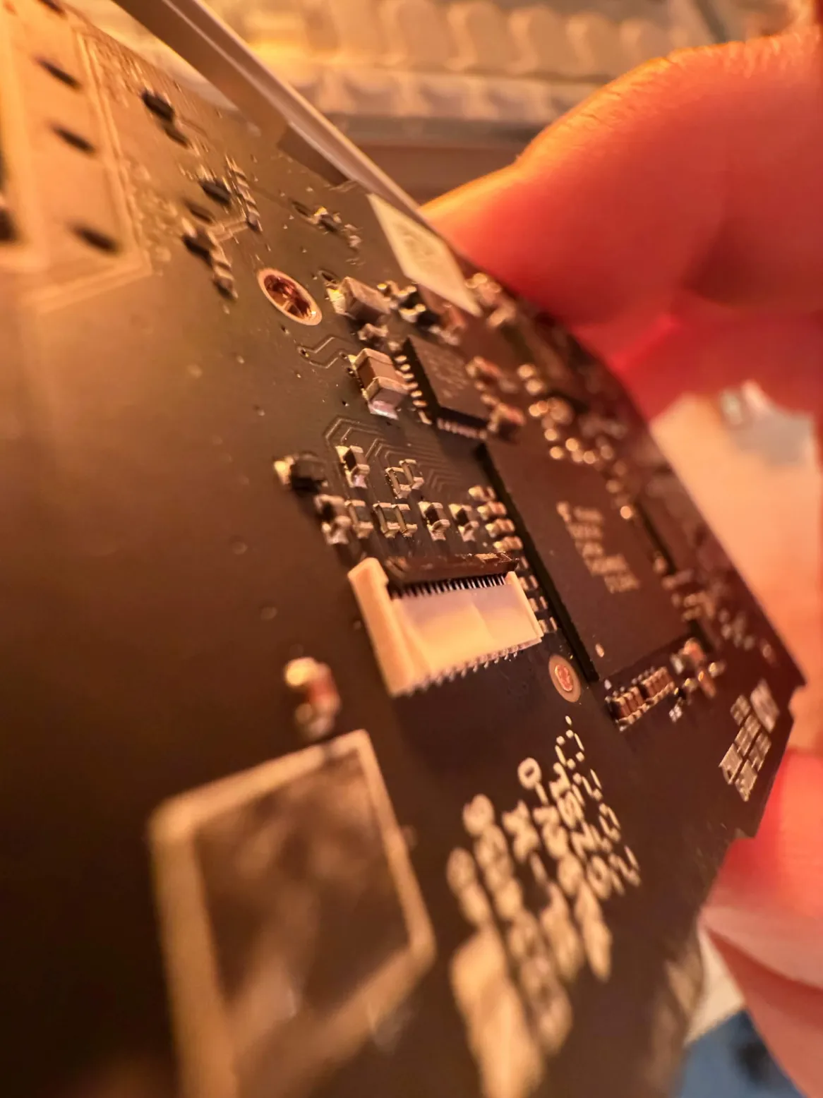 Lifting the small black FPC actuator lever from the back with a plastic tool