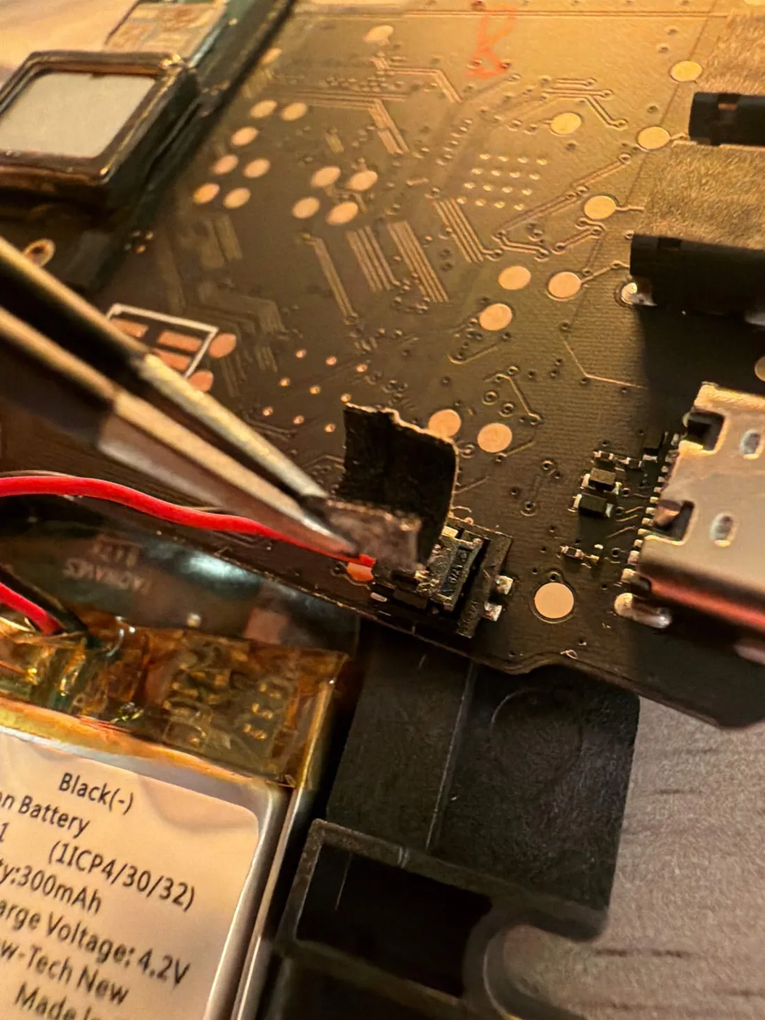 Peeling the foam tape off the SP-1 battery connector